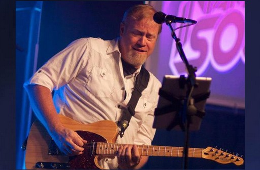 Cory Knowland on stage with electric guitar