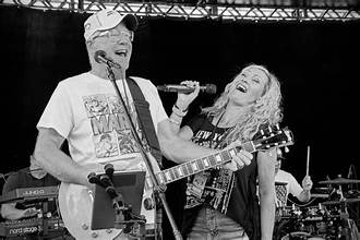 Cory performing on stage with a vocalist